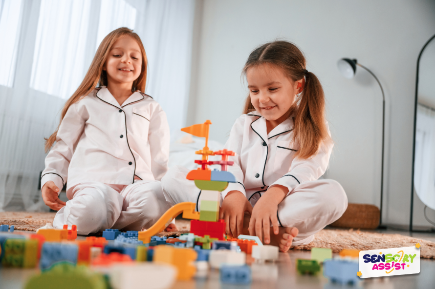 Christmas Gift Ideas for Siblings, sensory toys are on the floor. Two little girls are playing and having fun together in domestic room.