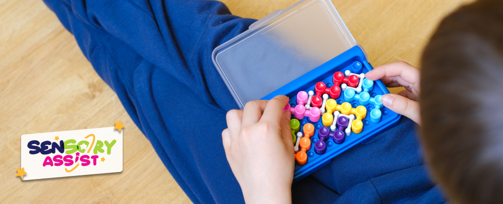 Kid playing with Smart IQ puzzle. Bright board designer game. The development of mindfulness