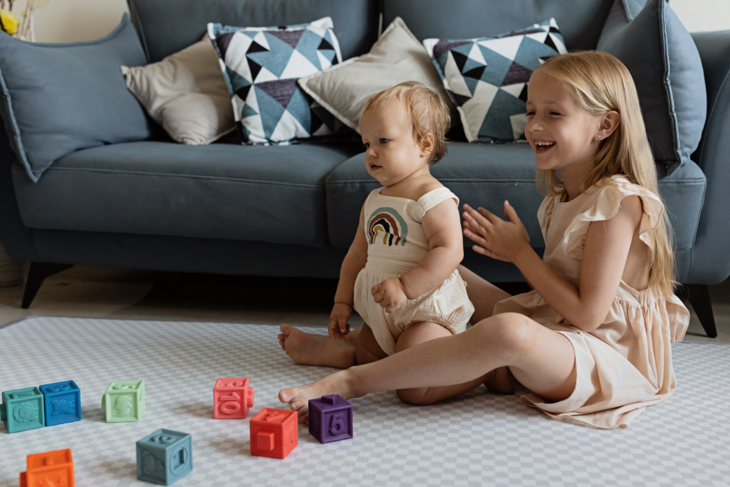 Siblings having fun when playing together at home on Mellow Mat 