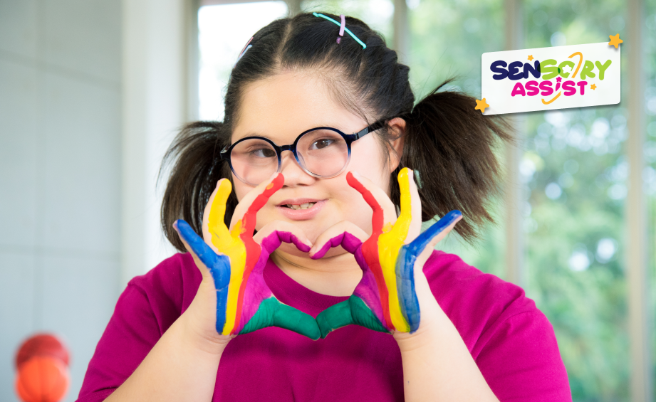 Autism disabled child kid genetic disorders down syndrome girl with colorful painted hands making a heart.