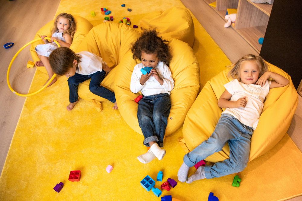kids lying on a Sensory Pod Plush filled beanbag in a Sensory-Friendly Space with Mellow Mat