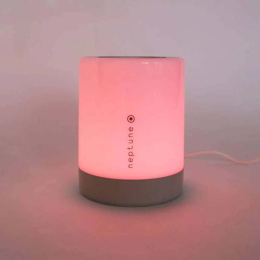 Sleep Lamp III glowing warmly in a bedroom at dusk