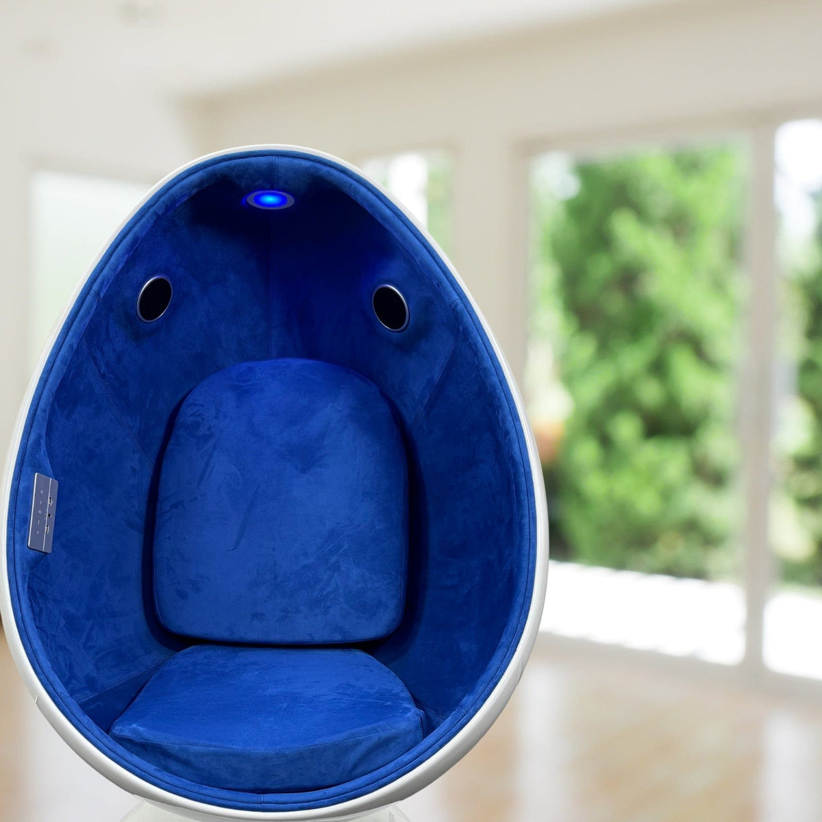 Blue sensory egg chair with padded seating and integrated lighting