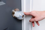 Finger opening a door with the EZ Door Knob Grip