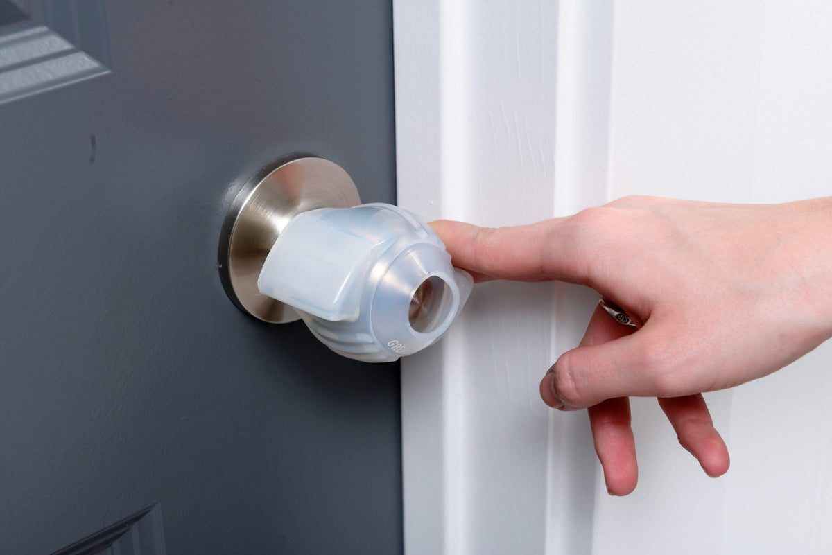 Finger opening a door with the EZ Door Knob Grip