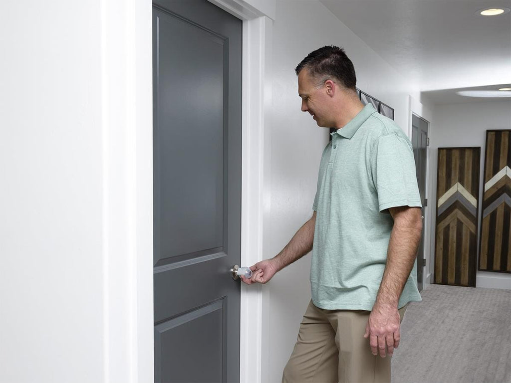 Man opening a door fitted with Great Grips
