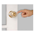 Finger pressing an EZ Door Knob Grip to turn the knob
