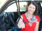 Woman using the Car Caddie handle while seated in the passenger seat