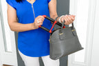 Woman carrying a handbag and the Handy Handle