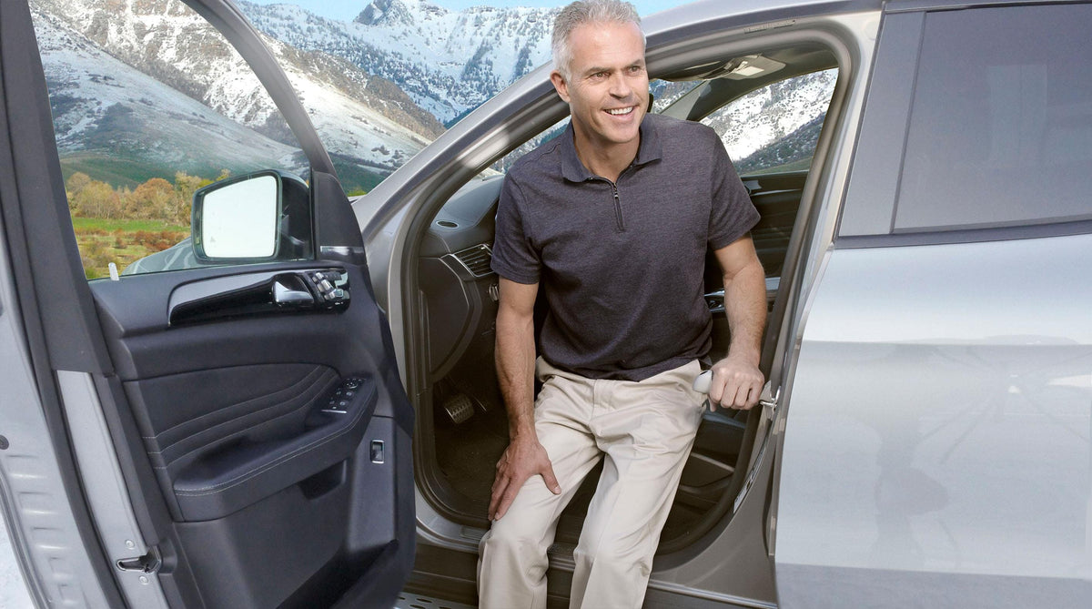 Man stepping out of a car using the Car Assurance Handle