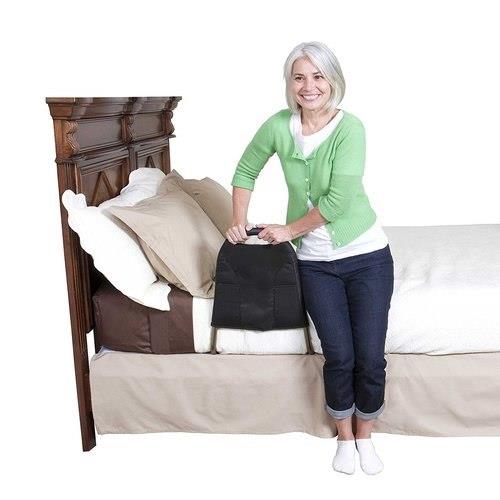 Woman standing beside the bed holding the Bedside MightyRail