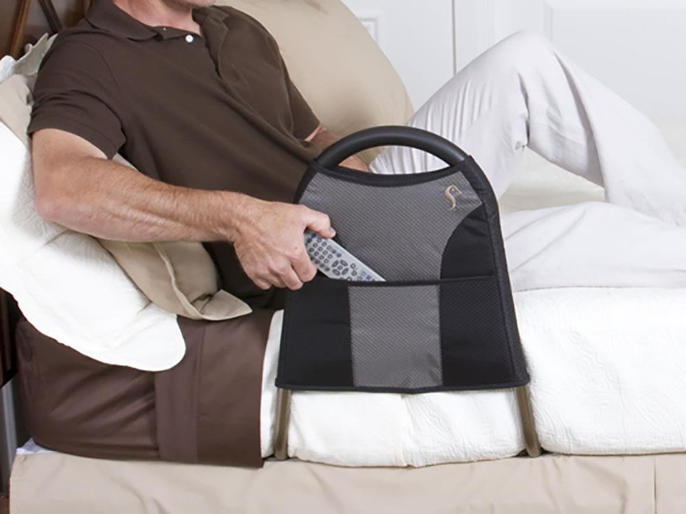 Hands placing items in the Bedside Econorail pouch