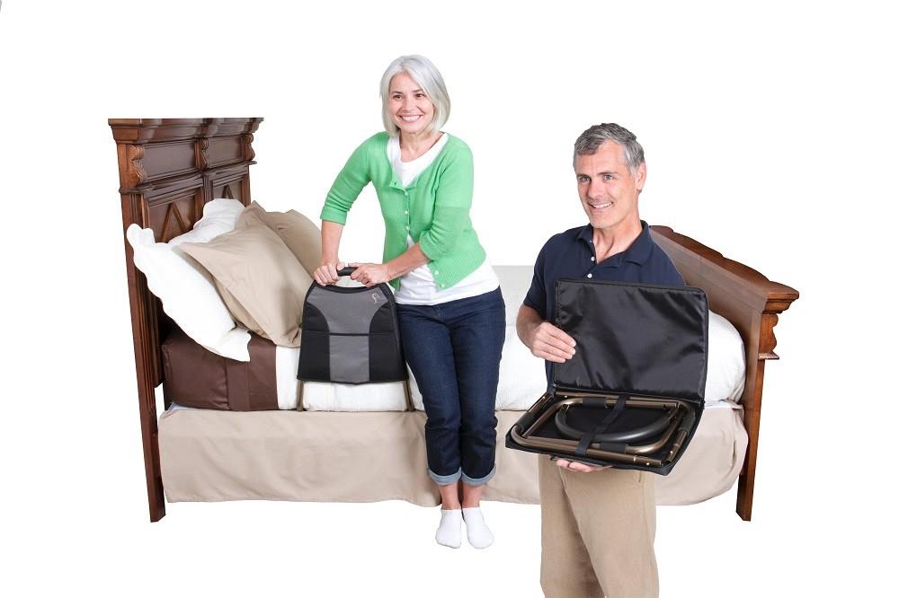 Couple sitting on a bed with the Bedside Econorail