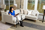 Man seated on a sofa using the EZ Stand-N-Go