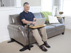 Man on a sofa with the Omni Tray