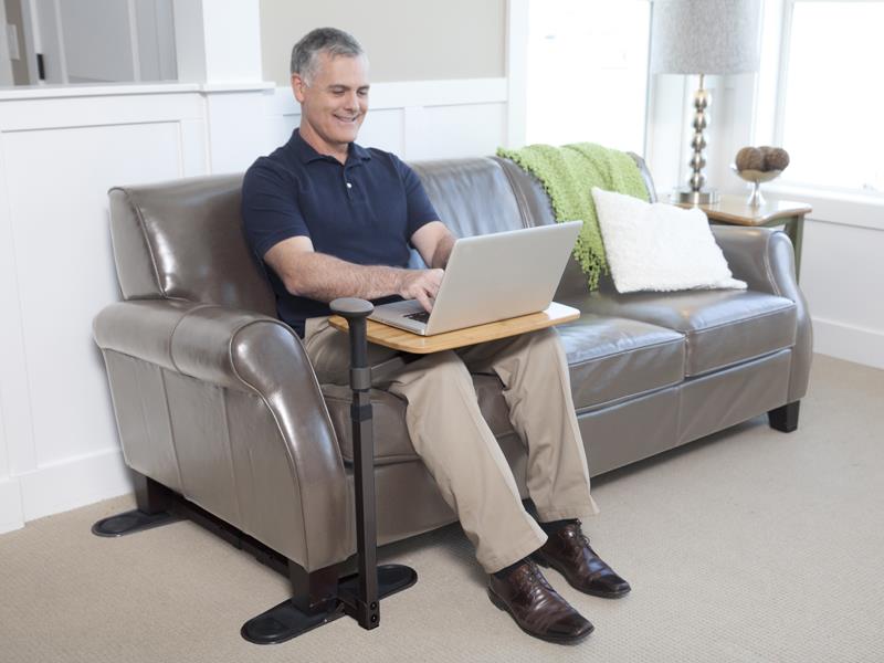Man on a sofa with the Omni Tray