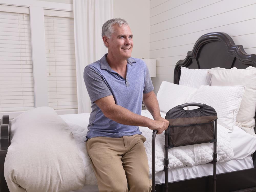Man getting out of bed with the Mobility Bed Rail