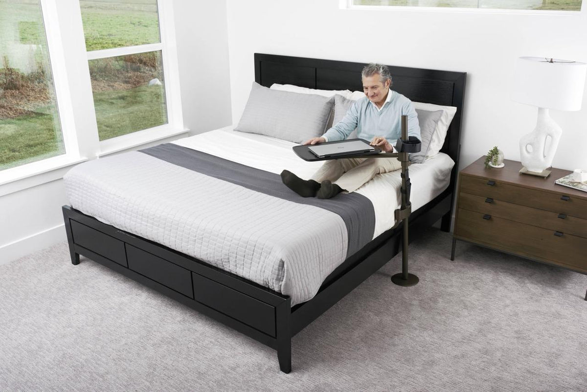 Freedom Overbed Table at an angle over the bed